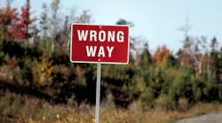A wrong-way sign along a roadway.
