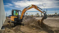 An operator using a CASE mini excavator on a job site.
