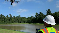A crew member using a drone for surveying and mapping purposes.