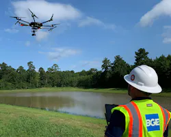 A crew member using a drone for surveying and mapping purposes.
